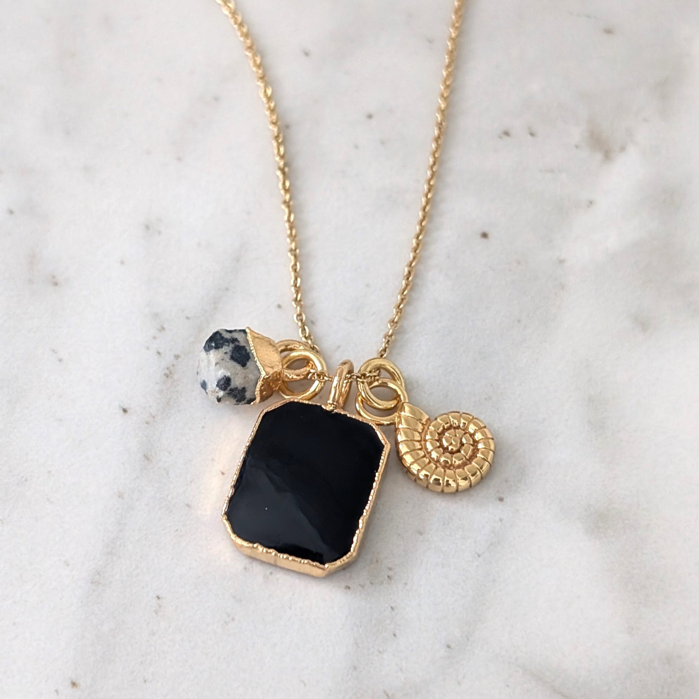 gold black onyx, dalmatian jasper and charm pendant necklace