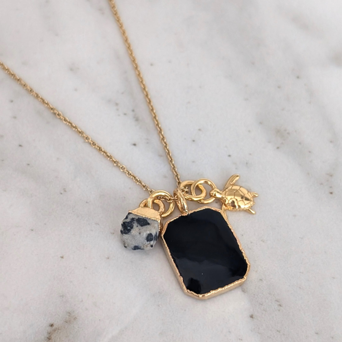 gold black onyx, dalmatian jasper and charm pendant necklace