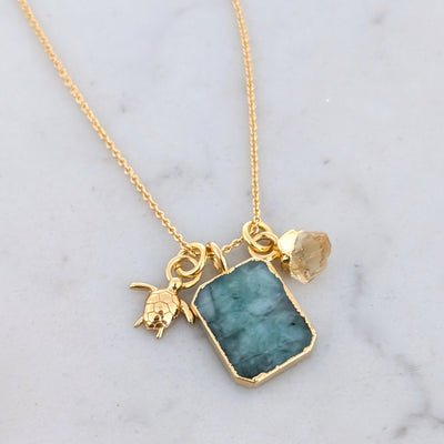 Emerald citrine and charm gold necklace